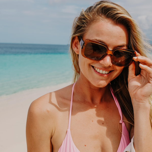 Imogen Caldwell wearing a pink bikini and oversized sunglasses