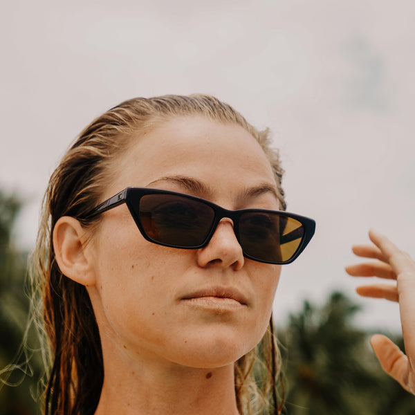 Imogen Caldwell wearing cat eye sunglasses with wet hair