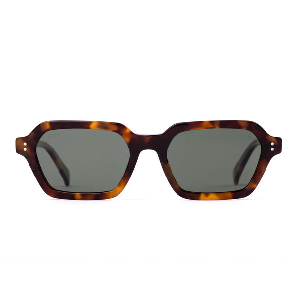 Sunglasses with tortoiseshell frame and dark lenses on a white background