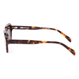 Sunglasses with tortoiseshell frame and dark lenses on a white background