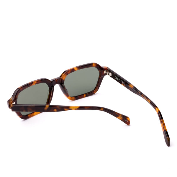 Sunglasses with tortoiseshell frame and dark lenses on a white background