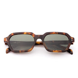 Sunglasses with tortoiseshell frame and dark lenses on a white background