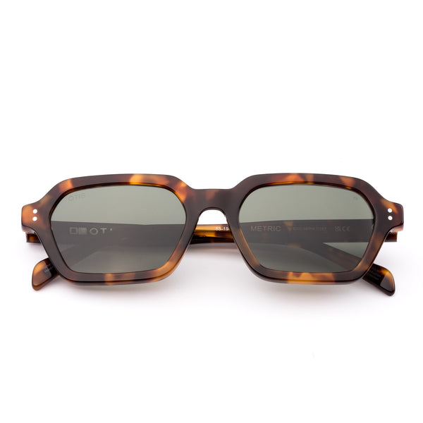 Sunglasses with tortoiseshell frame and dark lenses on a white background