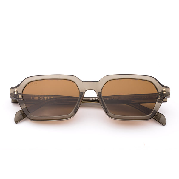 Sunglasses with a green transparent frame and brown lenses on a white background