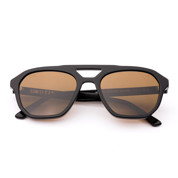 Aviator sunglasses with brown lenses and black frame on a white background.