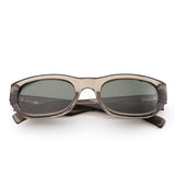 Sunglasses with a green transparent frame and dark lenses on a white background