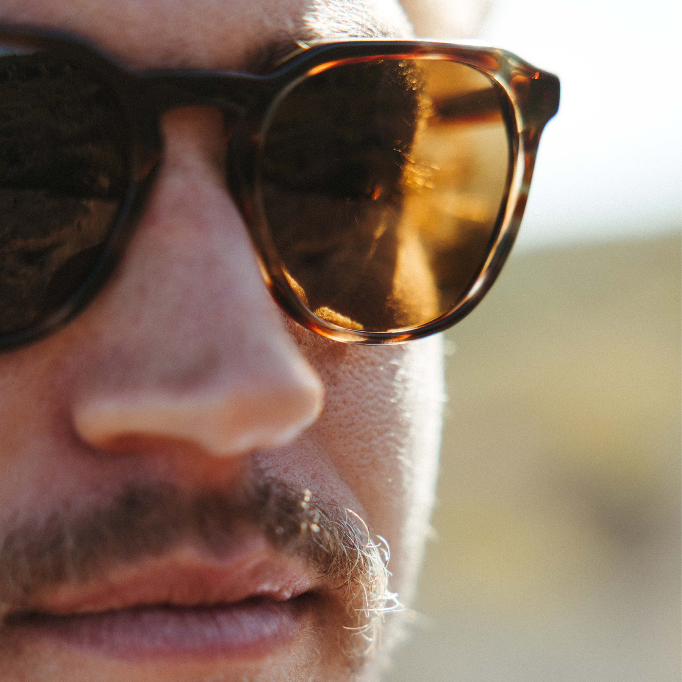 Man wearing sunglasses looking into the distance