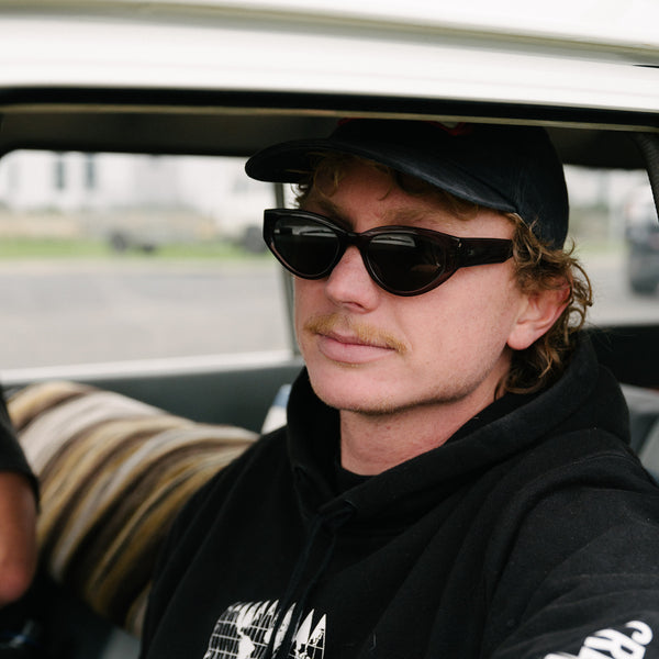 Man wearing OTIS sunglasses in a car 