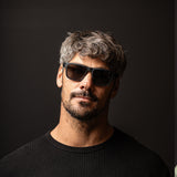 A headshot of Jay Davies wearing black top and black sunglasses