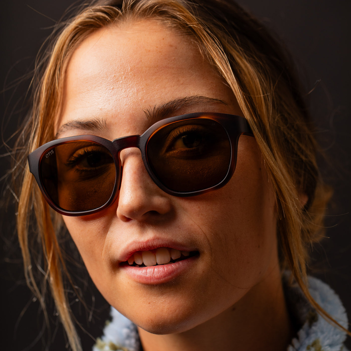 Girl wearing brown round sunglasses close up with blonde hair