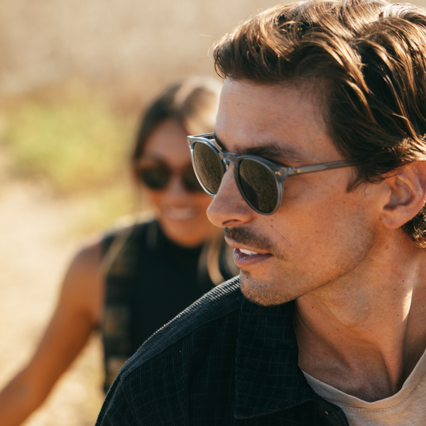 Male wearing blue round OTIS eyewear sunglasses in the afternoon sun