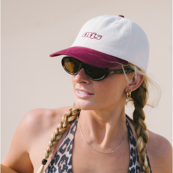 Woman with white and red cap, sunglasses and leopard print bikini at the beach