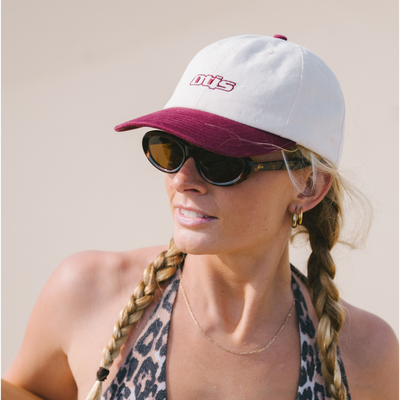 Woman with white and red cap, sunglasses and leopard print bikini at the beach