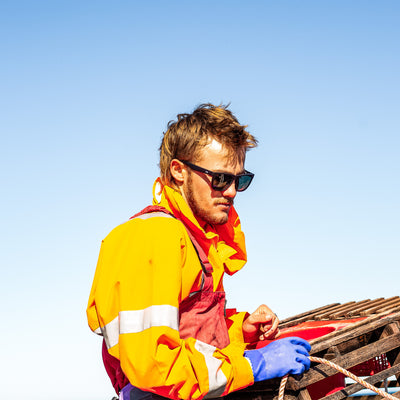 Crayfisherman pulling cray pots in black sunglasses