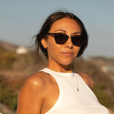 Corina Rose wearing scratch resistant sunglasses facing forward and smiling