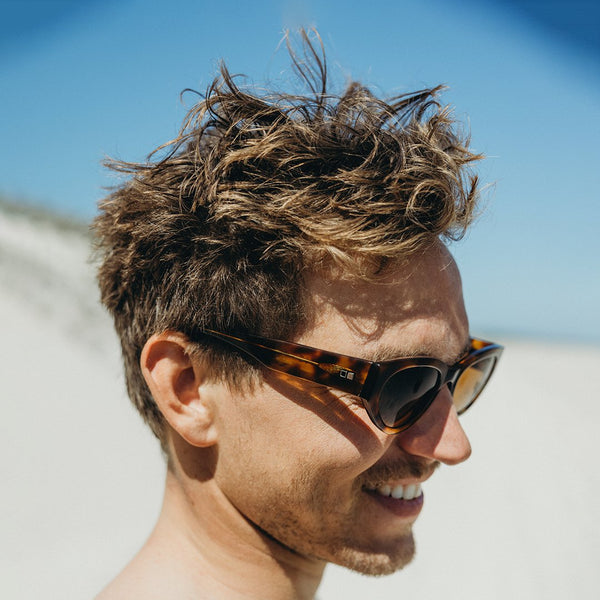 Surfer Man wearing sunglasses on the beach in Australia