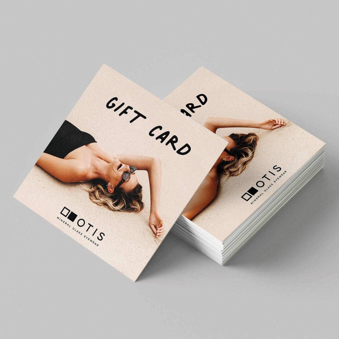 Mock up of giftcards with a girl lying down with mineral glass sunglasses on 