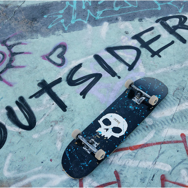 Jamie Thomas skateboard lying on the ground over graffiti