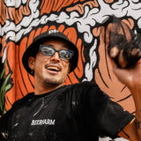 Artist Kentaro Yoshida wearing clear frame sunglasses with blue lenses