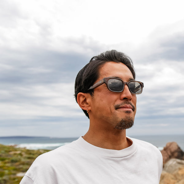 Artist Kentaro Yoshida smiling and wearing ethical sunglasses